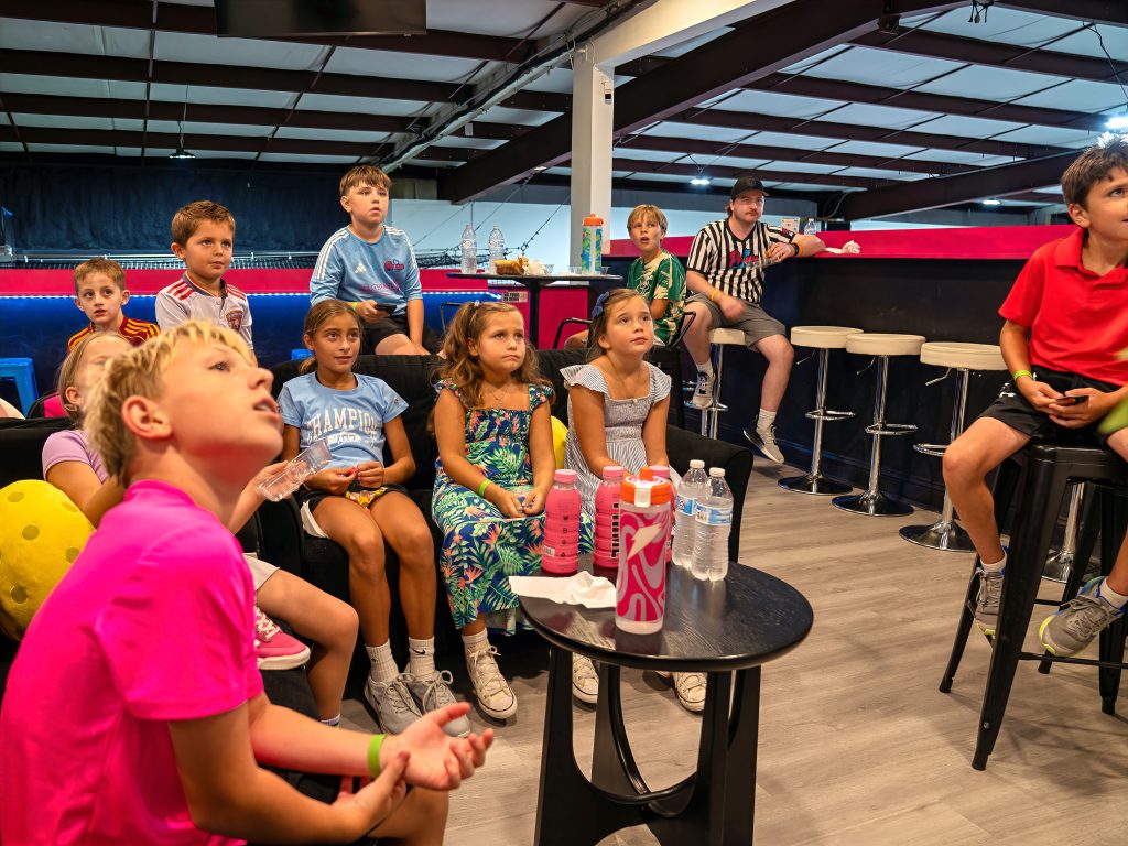 Kids watching a movie in the lounge during Prime Night Out